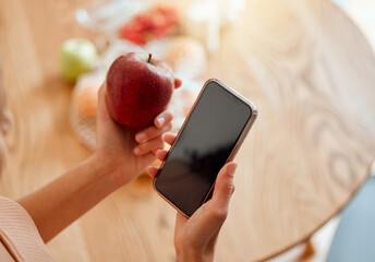 Online, health and apple organic fruit of woman holding phone and looking at nutrition value. Young female browsing diet and wellness plan or recipes to make for a healthy meal and lifestyle.