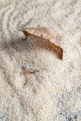 a pile of white rice in a paper bag and on the table