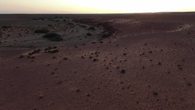 Martian landscape and red terrain of Erfoud desert in Morocco. Aerial forward view
