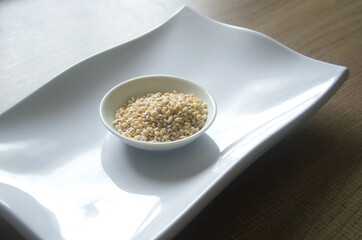 Bowl of organic pearl barley on white plate