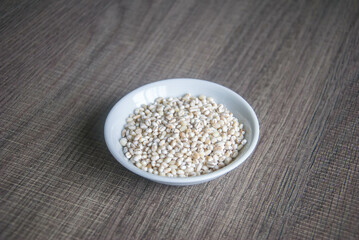Bowl of organic pearl barley on white plate