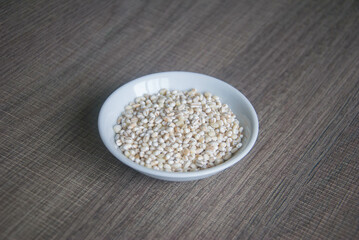 Bowl of organic pearl barley on white plate