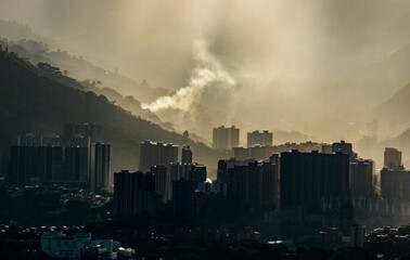 Smog contamination pollution in the mountains of the city of medellin colombia antioquia red and dirt