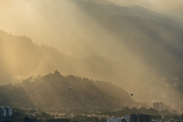 Naklejka na ściany i meble Smog contamination pollution in the mountains of the city of medellin colombia antioquia red and dirt