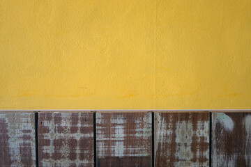 Yellow cement walls and pastel wood planks texture background 