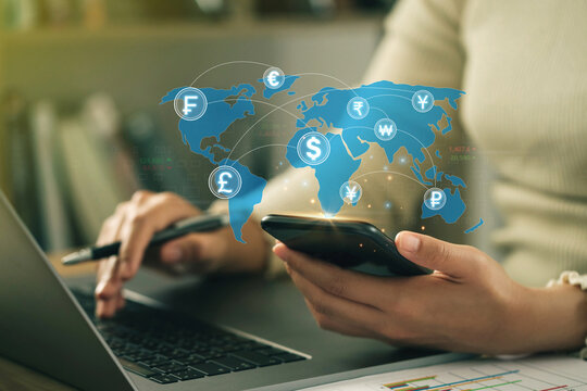 Businesswomen hold smartphones for money transfer and exchange, global currency, Currency exchange, and work in the global financial market via mobile devices. FinTech financial technology, - Powered by Adobe