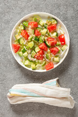 Salad of fresh vegetables and herbs with quinoa seeds and olive oil