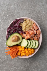 Poke bowl from Quinoa with salmon and vegetables, healthy lunch, balanced diet.