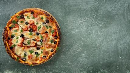 banner homemade pizza with cheese and cherry tomatoes, olives, herbs, sauce. Top view, copyspace for text.
