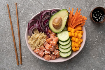 Poke bowl from Quinoa with salmon and vegetables, healthy lunch, balanced diet.
