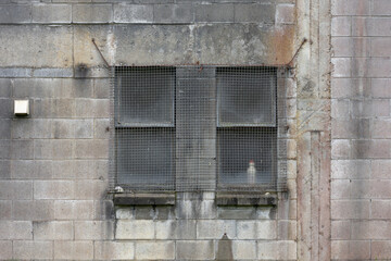 Fototapeta na wymiar Grey concrete block wall with two windows