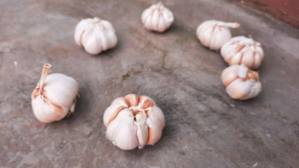 Blur Photo, A few cloves of garlic on an industrial cement floor