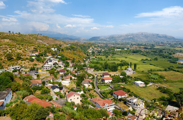 Picturesque view of neighborhoods Skodra in Albania on the background of mountains at sunny summer day, seen from Rozafa fortress.