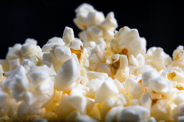 Extreme close-up horizontal photo of several stacked almost complete frame popcorns isolated, an...