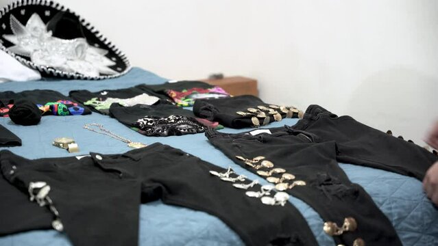 Guy organizing his clothes on the bed