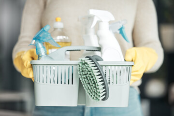 Closeup of house cleaning supplies, floor scrubbing and washing tools or products in an organized basket. Cleaner, housekeeper or maid with spray bottles and hygiene equipment for work or chores - obrazy, fototapety, plakaty