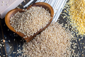 Fresh uncooked bulgur porridge on the table