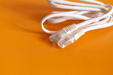 Internet cable on orange background, cable for internet connection