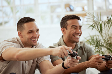 Smiling male friends playing video game console and having fun, hanging out together at home. Young men holding joystick controllers being playful and enjoying their free leisure break time