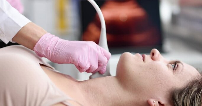 Young woman undergoes ultrasound of thyroid gland in modern clinic