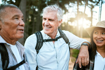 Hiking, adventure and exploring with a group of senior friends and retired adults enjoying a hike or walk outdoors in nature. Enjoying the view while on a journey of discovery in the forest or woods