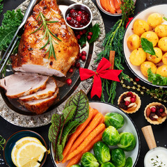 Traditional Christmas dinner on dark background.