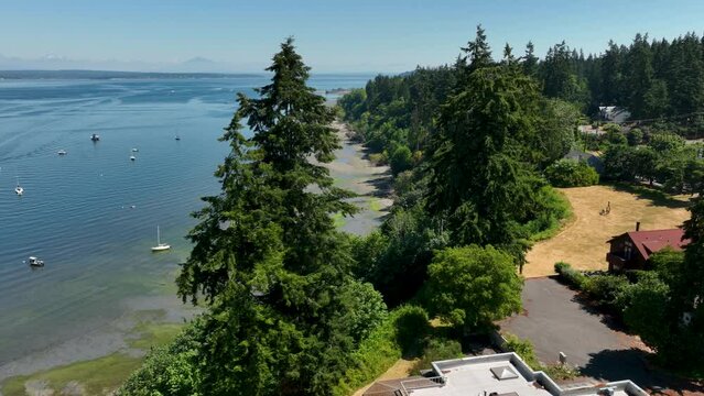 Aerial of Langley's shoreline at low tide with boats gloating in the bay.