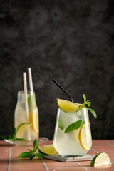 mojito cocktail with lime, Refreshing summer mojito cocktail with ice cubes, fresh mint and lime on black. Exotic mojito beverage