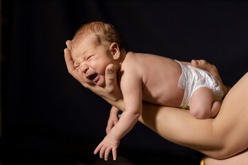 Fototapeta na wymiar newborn baby on black background