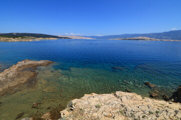 Fototapeta na wymiar The rocky shores of the beaches in Croatia are azure blue in the Adriatic Sea