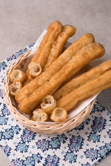 Cakwe or You tiao is a long golden-brown deep-fried strip of dough or typical chinese doughnut....