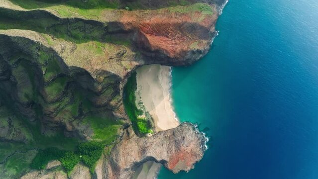 Epic aerial of Na Pali coast secret Beach, world famous incredible place for visit on Hawaii islands. Helicopter tour view of amazing natural landscape. Jurassic world pure untouched nature 4K Aerial