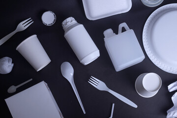 Plastic waste collection on dark background. Concept of recycling plastic and ecology.