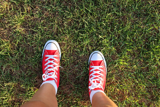 Top view image of girl with red shoes