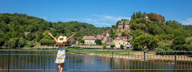 Woman travelling in Dordogne,  village of Limeuil