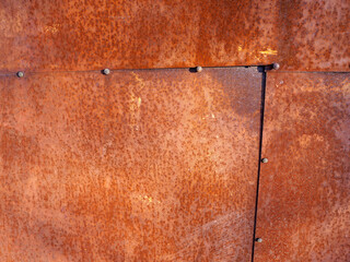 beautiful background of an old solid metal garage wall with corrosion and rust