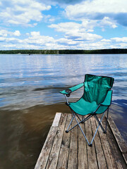 beautiful river view with a fishing chair on the pier that can be used as a mockup