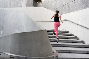 Young woman running fast on the ladder