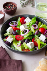 Greek salad with feta cheese, tomatoes, cucumbers, peppers and Kalamata olives. Healthy eating. Vegetarian food.
