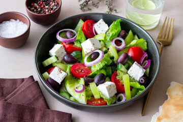 Greek salad with feta cheese, tomatoes, cucumbers, peppers and Kalamata olives. Healthy eating. Vegetarian food.