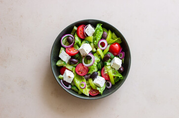 Greek salad with feta cheese, tomatoes, cucumbers, peppers and Kalamata olives. Healthy eating. Vegetarian food.