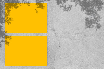 Empty yellow square poster mockup with light shadow on gray concrete wall background.