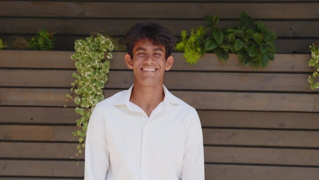 Happy young Indian entrepreneur smiling toward camera