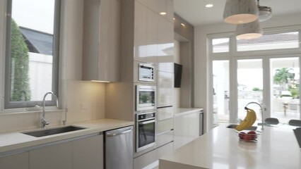 Luxury cozy dining room and kitchen of modern villa, gimbal motion view - Powered by Adobe