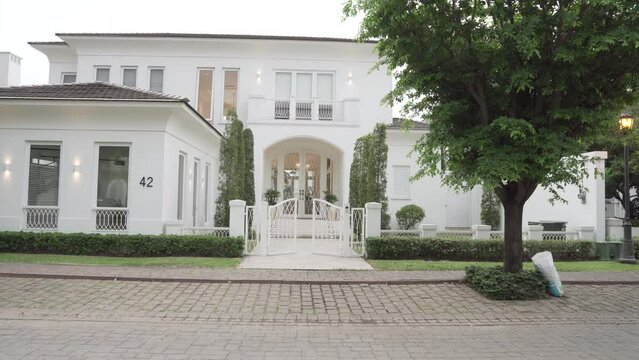 POV walking into modern luxury home villa through gates and doors
