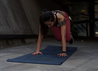 Fototapeta na wymiar Asian woman exercising on yoga mat