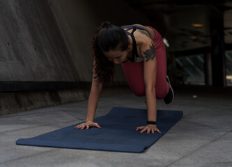 Asian woman exercising on yoga mat