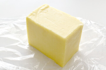 Cheese on plastic wrap.  Photo can be used for the concept of how to store cheese properly concept. 