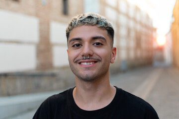 Handsome man outdoors portrait. Man smiling, looking in the camera
