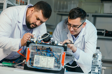 Two scientists are working on the development of a new device